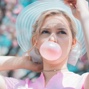 lady Blowing bubble gum wearing a fance hat
